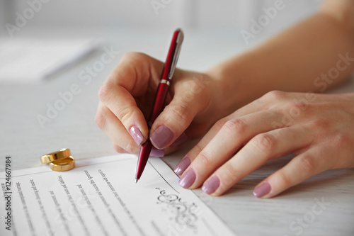 Woman signing marriage cont...