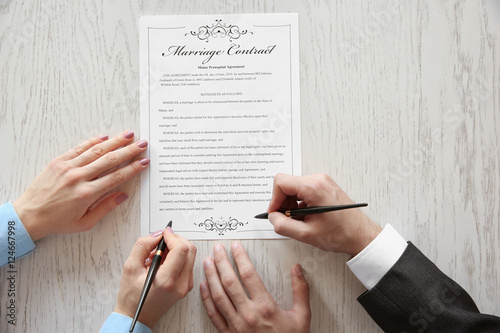 Couple signing marriage con...