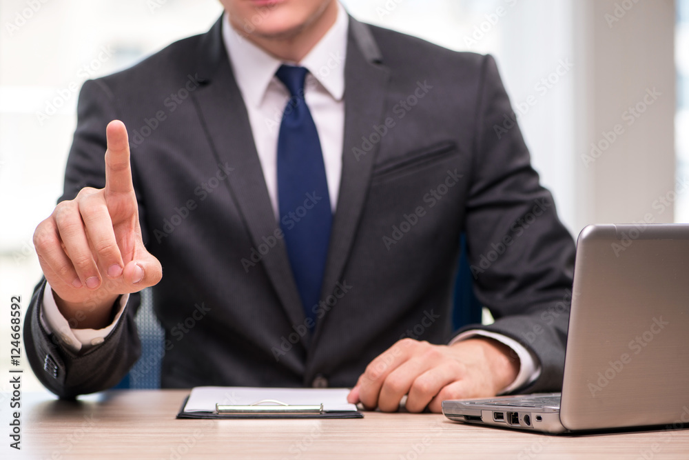 Young businessman pressing buttons in business concept Young businessman pressing buttons in business concept