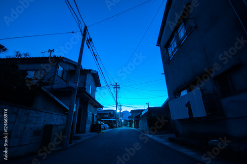 Fototapeta Naklejka Na Ścianę i Meble -  Dawn of small Japanese town with mountain in the back