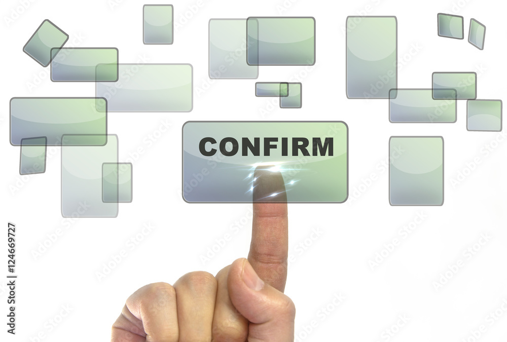 Businessman hand pushing on a touch screen interface on confirm button Businessman hand pushing on a touch screen interface on confirm button