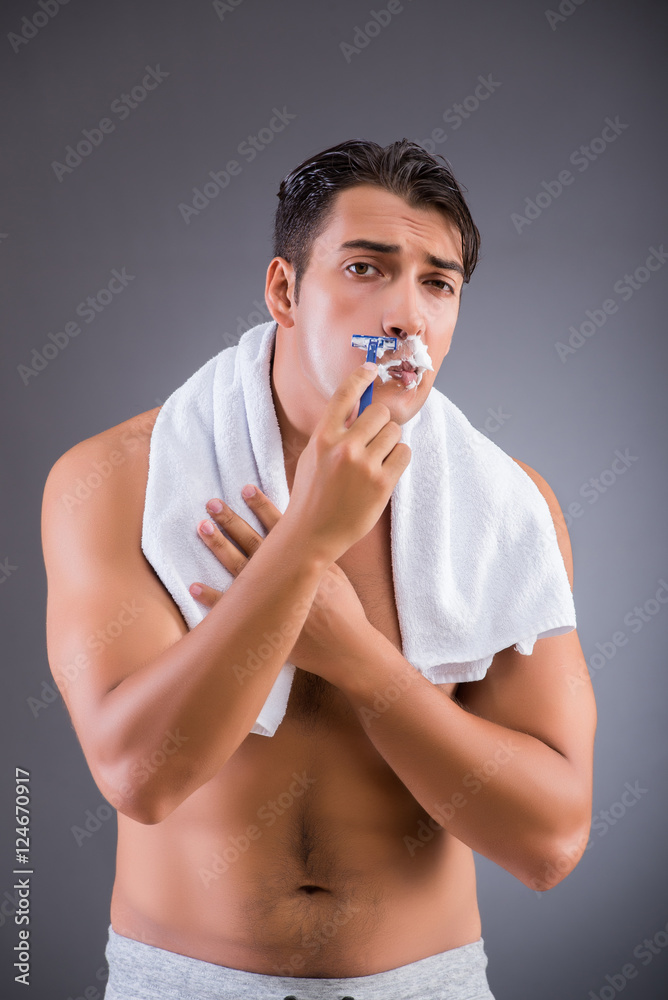 Man shaving on dark background Man shaving on dark background
