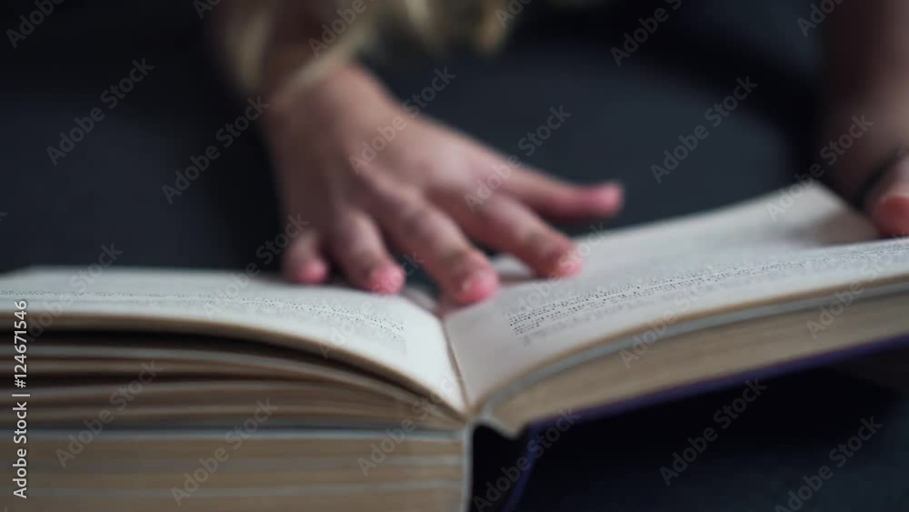 Woman's Hand Flip Page Reading the Book