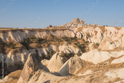 Ancient town and a castle of Uchisar dug from a mountains after sunrise, Cappadocia, Turkey