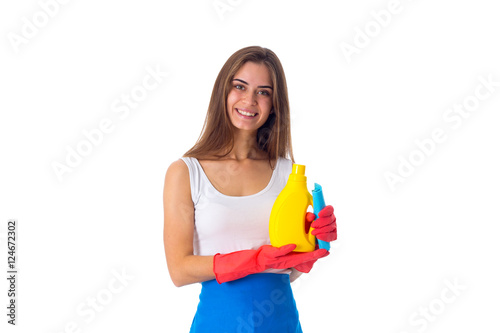 Woman holding duster and detergent 
