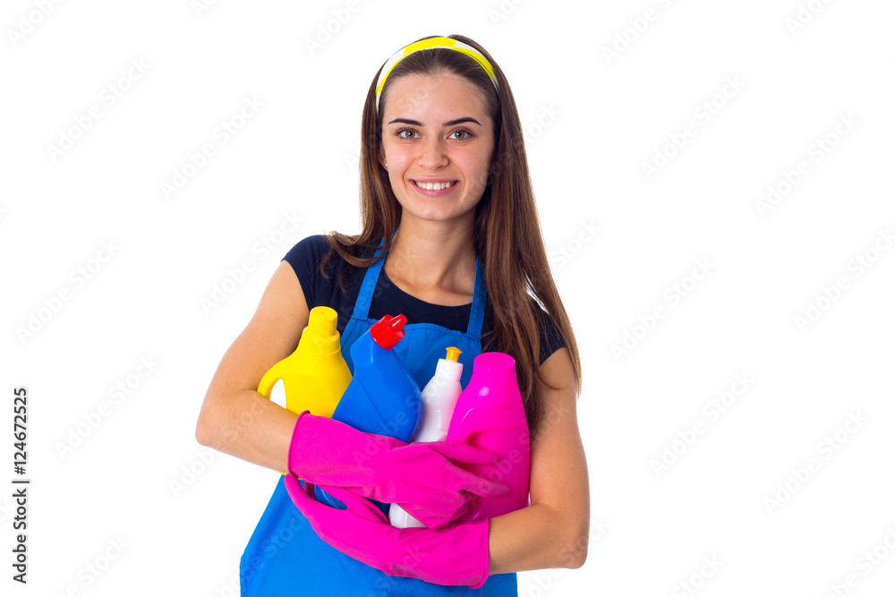 Woman in apron holding a detergents Woman in apron holding a detergents