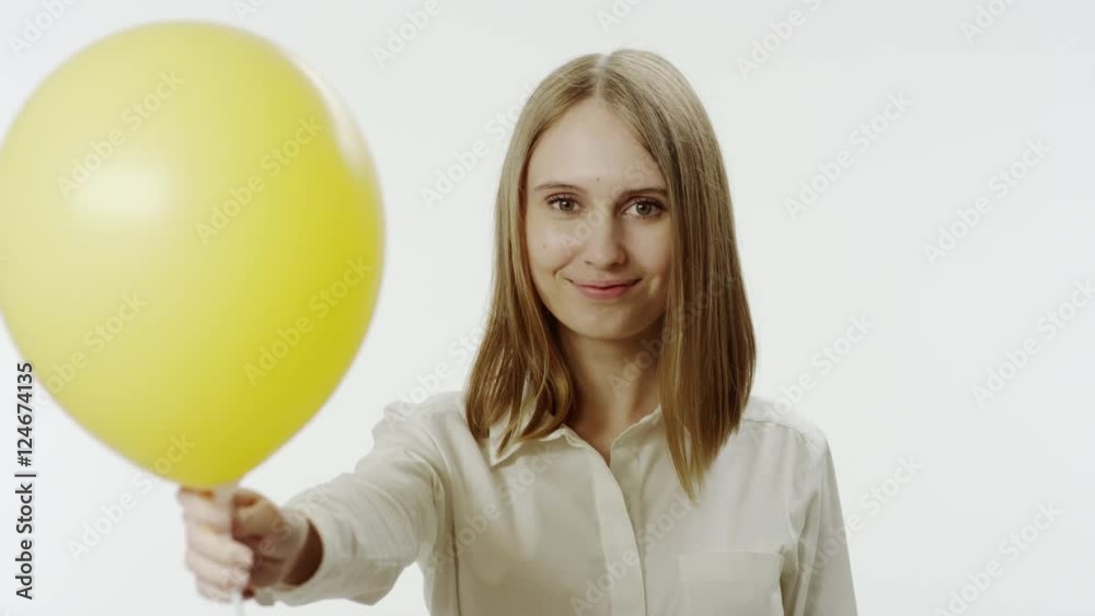 Portrait of smiling woman with yellow balloon Portrait of smiling woman with yellow balloon