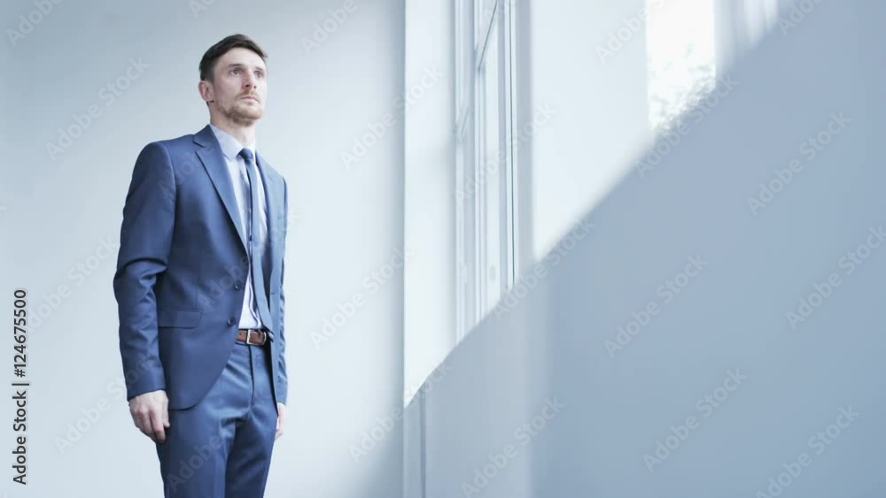Young businessman raising his hands in disbelief Young businessman raising his hands in disbelief
