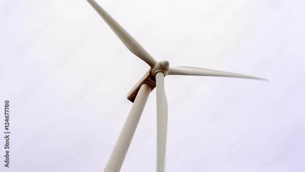 Close-up of windmill in low-angle shot, with overcast sky of a rainy day. Panoramic movement from left to right Close-up of windmill in low-angle shot, with overcast sky of a rainy day. Panoramic movement from left to right