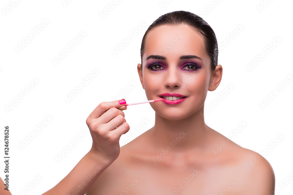 Woman applying lipstick isolated on white Woman applying lipstick isolated on white
