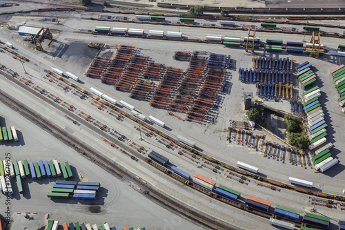 Aerial of unloading container trailers at railway terminal, USA. Railroad tracks, containers, trailers