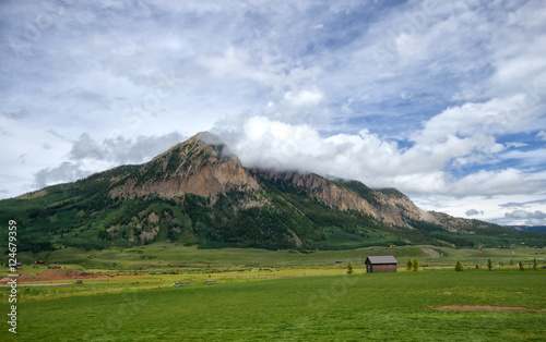 Mt Crested Butte on a summerday with clouds rolling over the pea