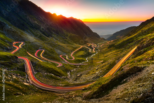 Traffic trails on Transfagarasan pass at sunset. Crossing Carpathian mountains in Romania, Transfagarasan is one of the most spectacular mountain roads in the world. photo