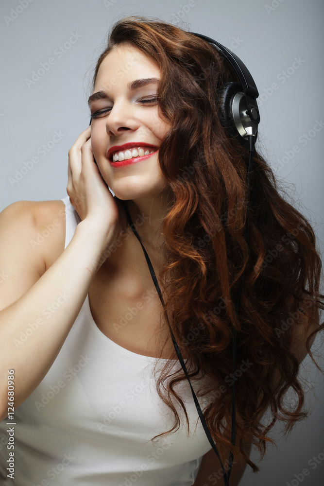 Fototapeta premium Young woman with headphones listening music