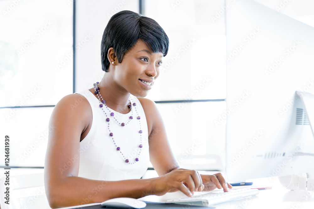 Portrait of businesswoman working at her desk in office Portrait of businesswoman working at her desk in office