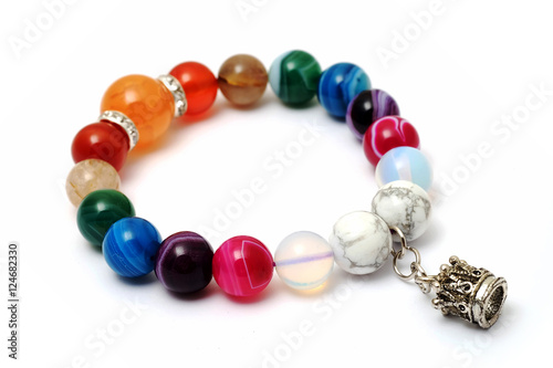 Colorful of agate,jasper bracelet decorate with silver crown pendant with white isolated background