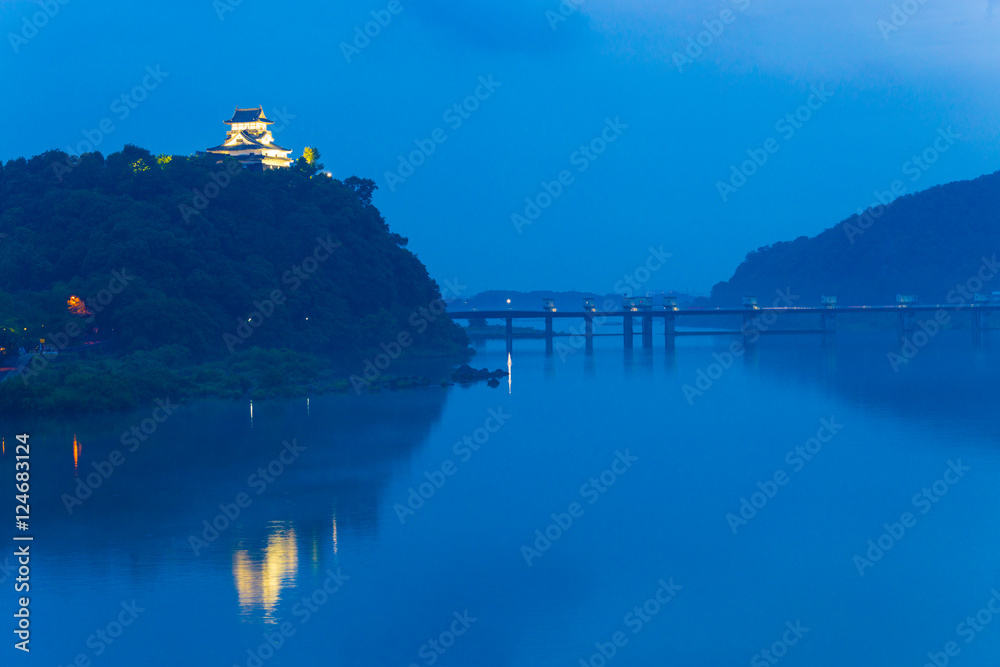Fototapeta premium Far Illuminated Inuyama Castle Night River Blue