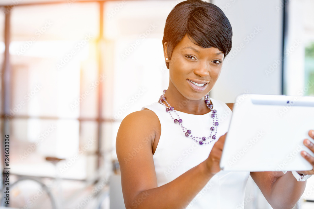 Young woman in office using tablet