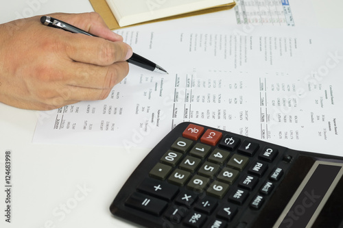 Hand of accountant checking financial document