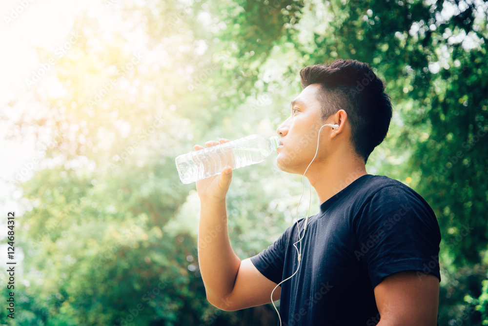 Handsome Young man drinking water from a bottle After Training. Handsome Young man drinking water from a bottle After Training.