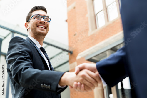 Two businessmen shaking their hands © Sergey Nivens