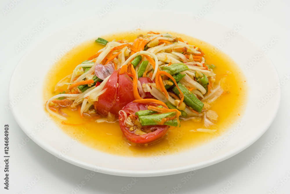 Spicy green papaya salad or somtum isolated on white background with copy space for text, Thai cuisine