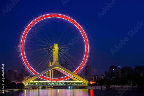 Fototapeta Naklejka Na Ścianę i Meble -  Night scene cityscape of Tianjin ferris wheel,Tianjin eyes with