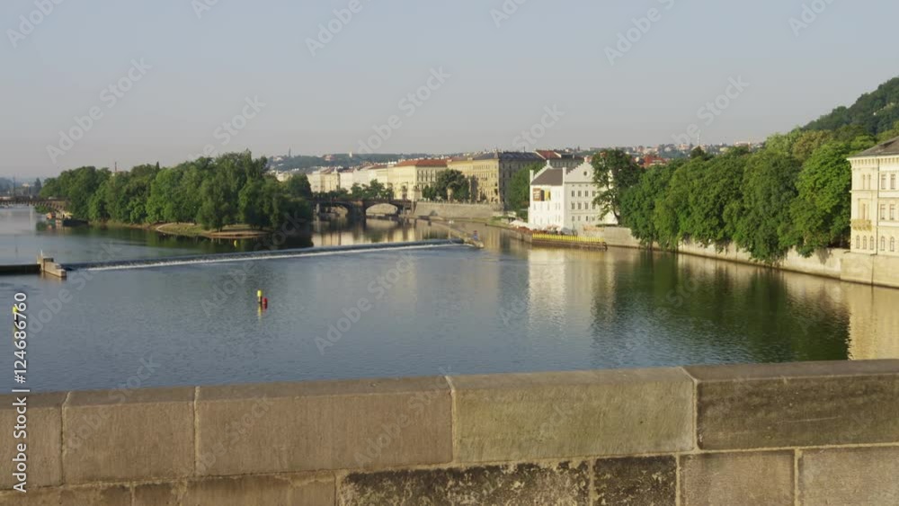 A moving shot of the view south from Charles bridge over the Vltava river. A fisherman is on a boat. 4k. A moving shot of the view south from Charles bridge over the Vltava river. A fisherman is on a boat. 4k.