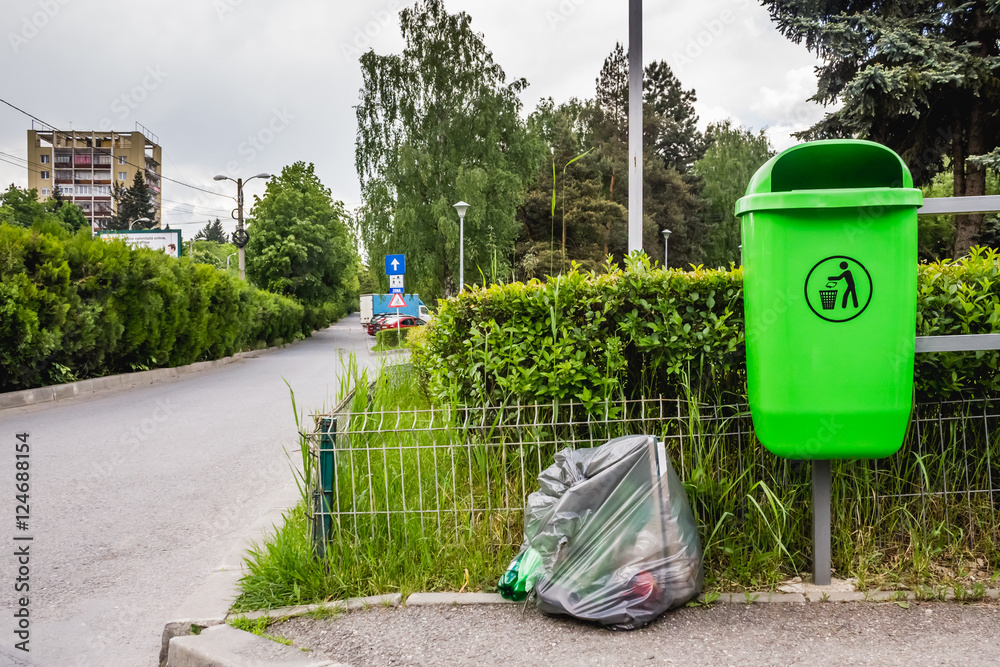 Dumpster with a full garbage bag Dumpster with a full garbage bag