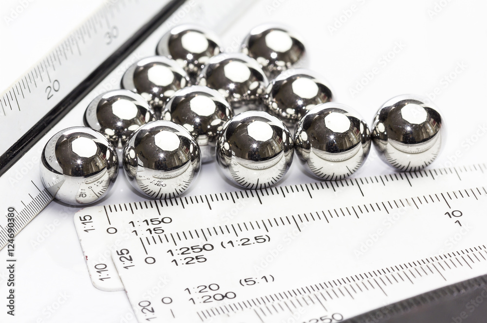 Ruler scale and ball bearings on white background Ruler scale and ball bearings on white background