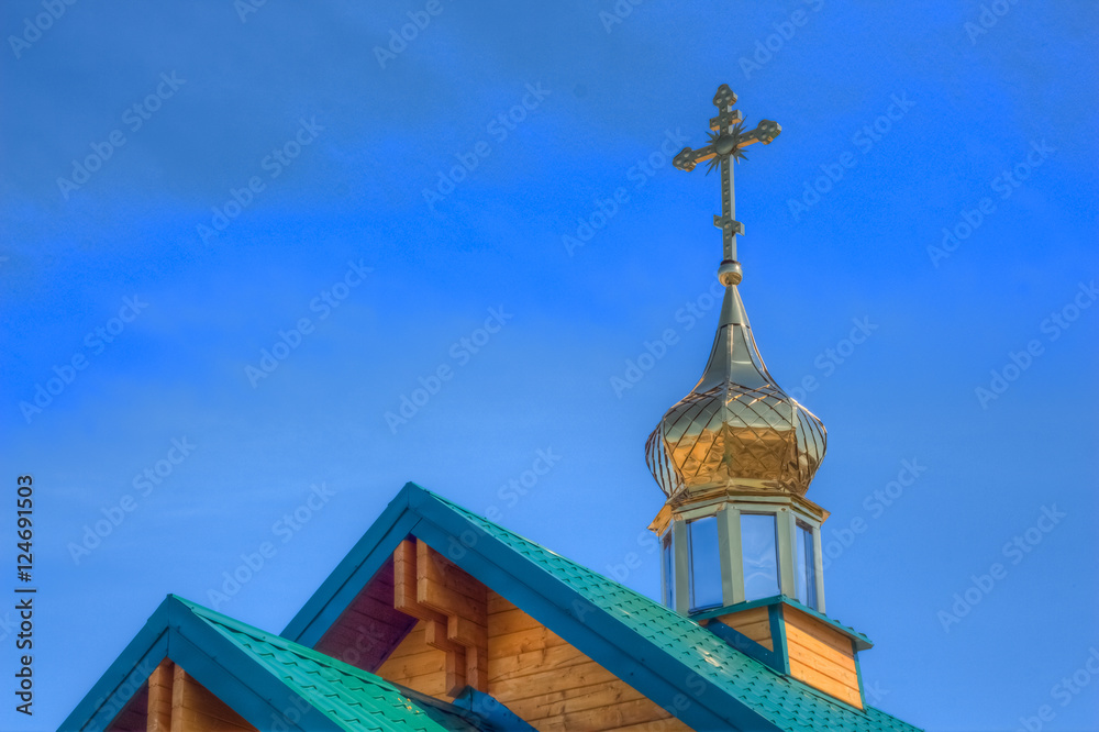 The dome of a temple with a cross on the roof. Orthodox Church
