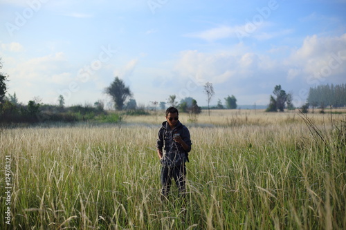 Man and White field grass flower at Thailand