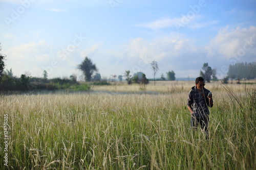 Man and White field grass flower at Thailand