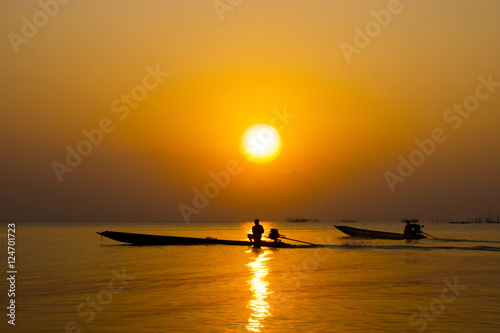 silhouette of fishermen in a boat.