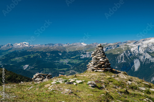 Stone Cairn on Mountain Peak Overlooking Panoramic Alpine Views in Brambrüesch, Graubünden, Switzerland