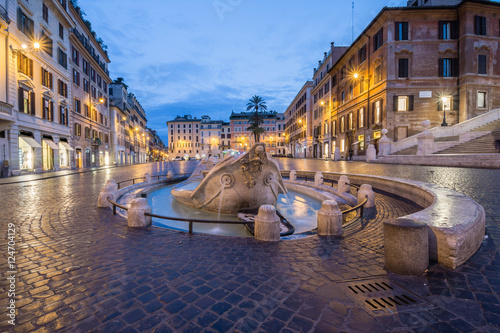 Barcaccia fountain in Piazza di Spagna by night, Rome, Italy photo