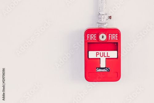 Old red box fire alarm  on cement wall