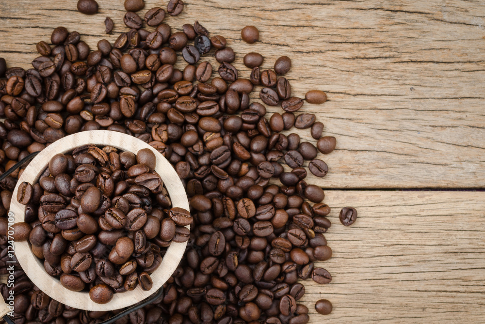 Fototapeta premium Coffee beans set up on wooden cask and rustic background