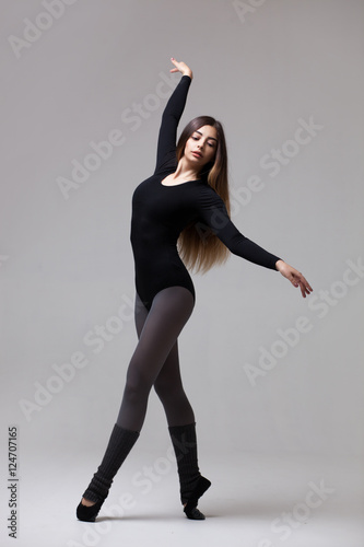 young woman dancer in black swimsuit posing