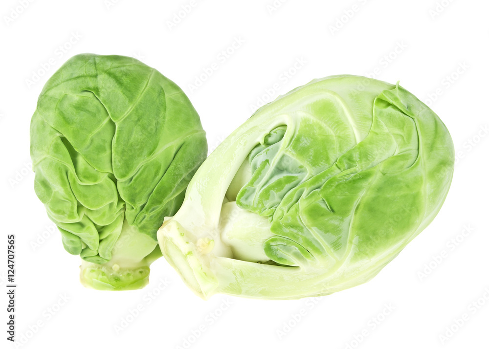 Obraz premium Close up view of two heads of brussels sprout on white backgroun
