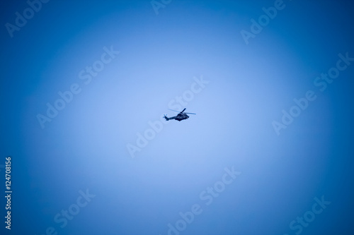 Military helicopter in deep blue sky