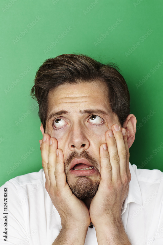 Man groaning in green studio Photos Adobe Stock Man groaning in green studio Photos Adobe Stock