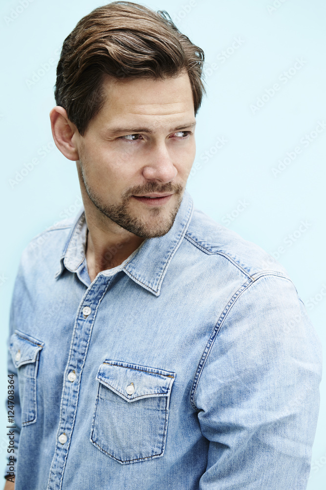 Man in blue shirt, looking away