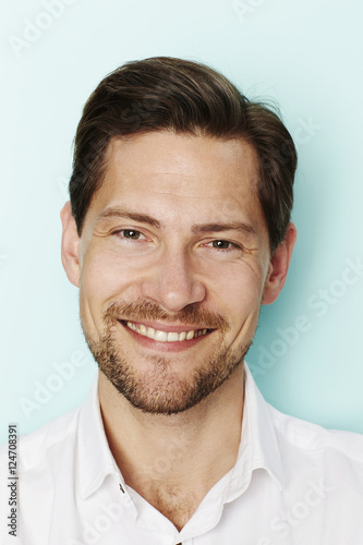 Smiling man in studio, portrait