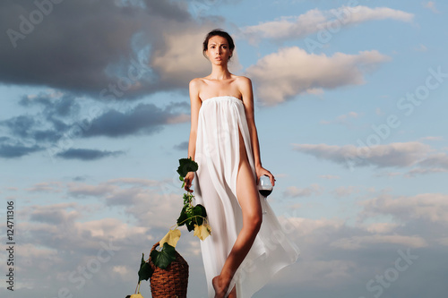 pretty girl with wine bottle over sky