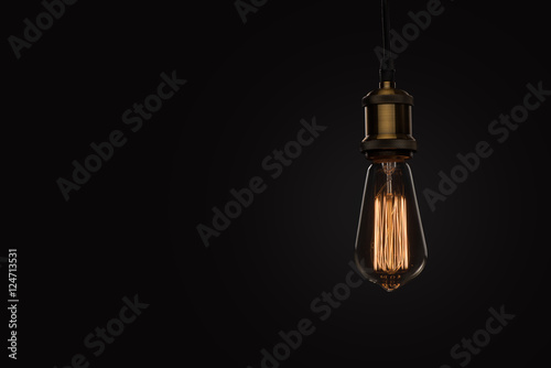 Photo classic Edison light bulb on black background
