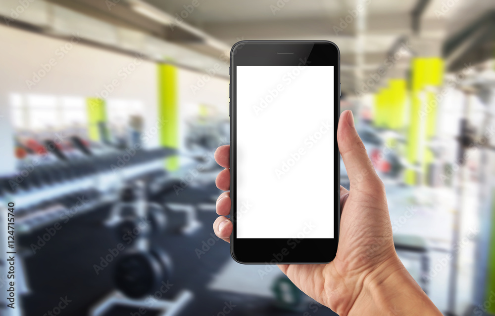 Mobile phone in sport gym. Isolated white screen for mockup. Mobile phone in sport gym. Isolated white screen for mockup.