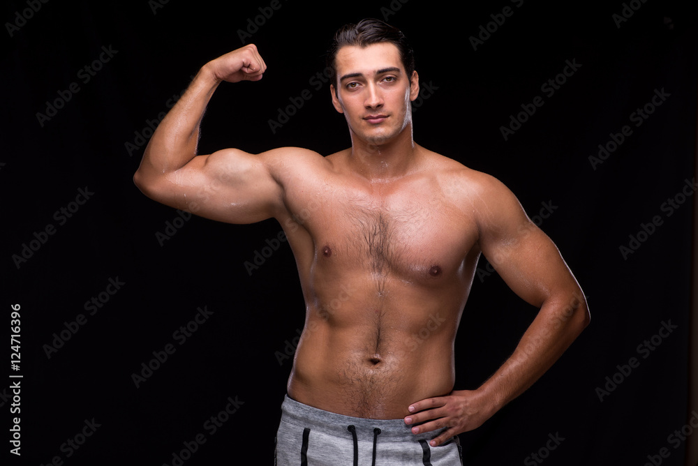 Fototapeta premium Ripped muscular man on black background