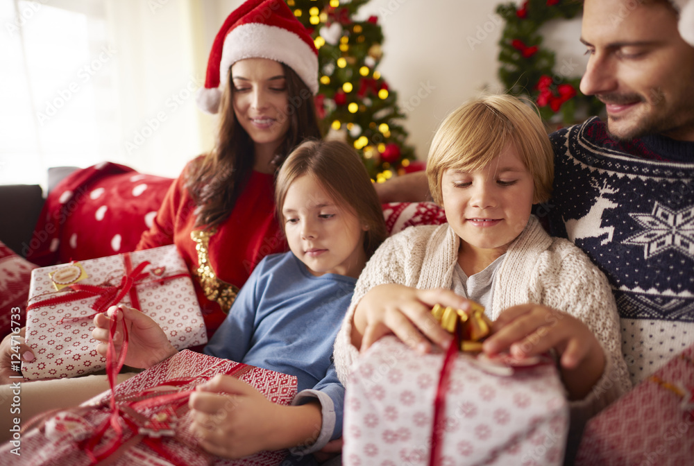 Family opening Christmas presents at home Family opening Christmas presents at home