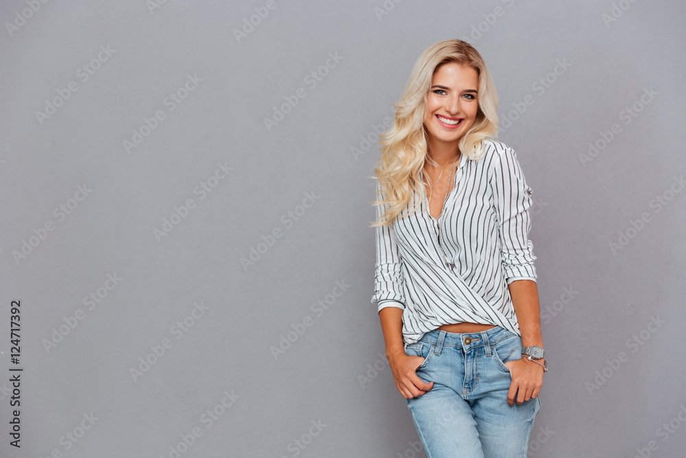 Portrait of a smiling woman standing with hands in pockets Portrait of a smiling woman standing with hands in pockets